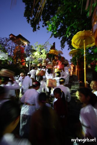 People entering the temple, some with their offerings